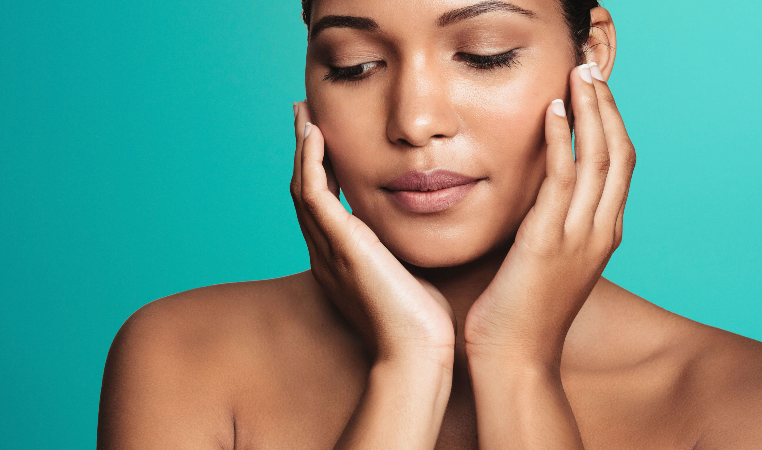 Close-up of a woman with eyes closed framing her face with both hands against for Endolift laser skin lifting in London