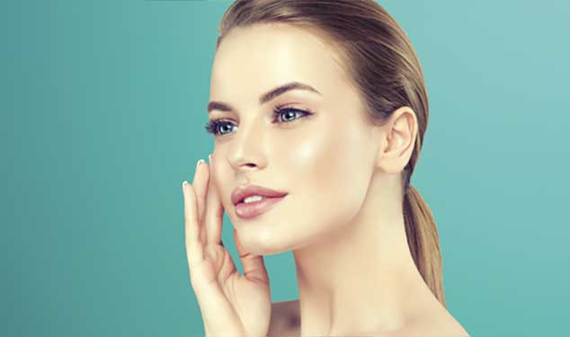 Woman in profile touching her cheek with one hand against a teal background for Endolift laser skin lifting in London